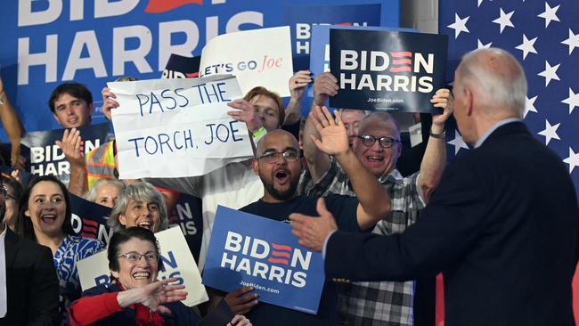 A supporter of US President Joe Biden holds a sign that read ‘Pass the torch Joe’during the campaign event Picture: Saul Loeb / AFP