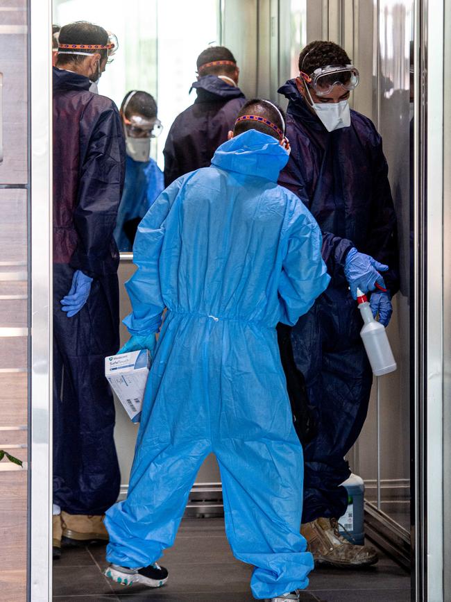 Workers dressed in full personal protective equipment were called in to clean a Darwin CBD building occupied by several Federal Government departments on Wednesday. Picture: Che Chorley