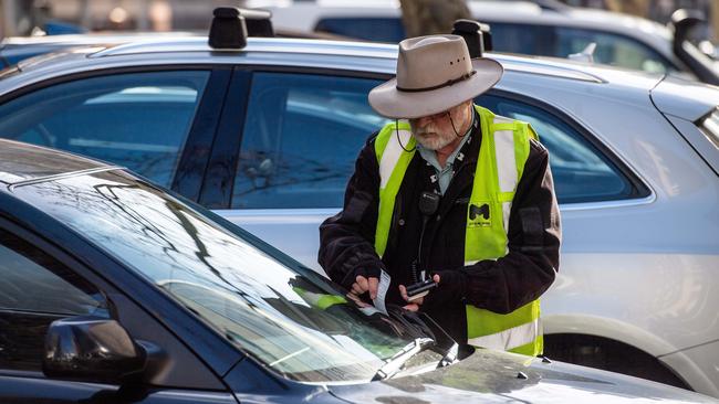 A City of Melbourne parking inspector in action. Picture: Jason Edwards