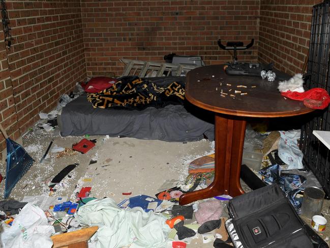 A used mattress and debris in one of the garages at the site of a garage fire. Picture: Tracey Nearmy