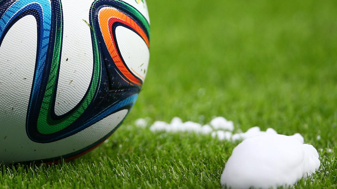 PORTO ALEGRE, BRAZIL - JUNE 15: A "Brazuca" match ball sits near a temporary line sprayed by the referee for a free kick during the 2014 FIFA World Cup Brazil Group E match between France and Honduras at Estadio Beira-Rio on June 15, 2014 in Porto Alegre, Brazil. (Photo by Paul Gilham/Getty Images)