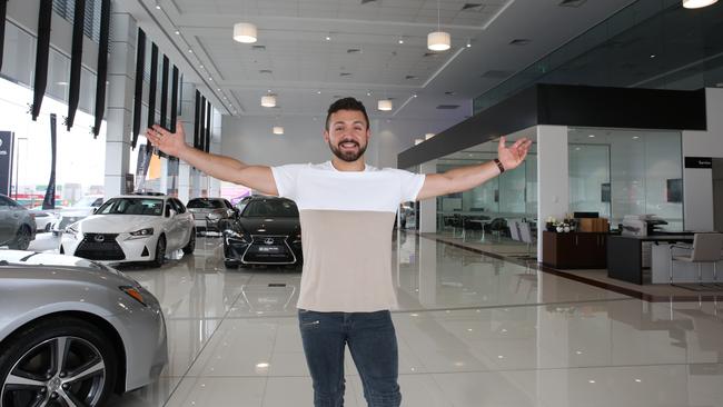 Alfie shows off the Clinton’s Toyota and Lexus of Macarthur dealership he worked on with Mosca Pserras Architects before his singing career took off. Picture: Robert Pozo