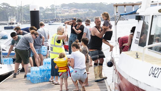 The scene at Ulladulla where Locals are using their own boats to take supplies and rescue people from Bendalong, Manyana, Cunjurong Point and Lake Conjola towns that are isolated due to the fires. Picture: Darren Leigh Roberts