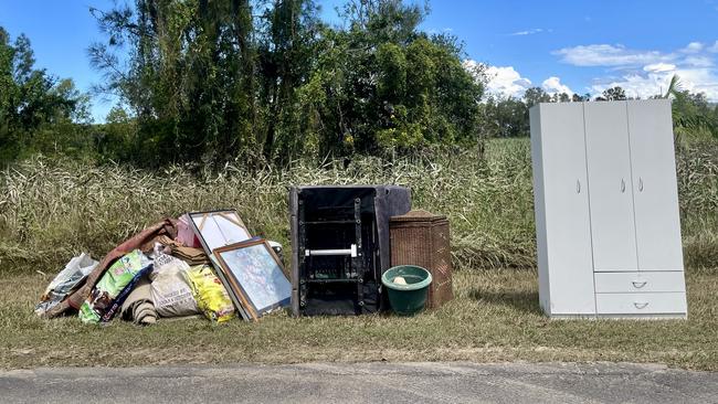 Flood waste in Harwood sits in the sun as residents say council clean up has taken too long.