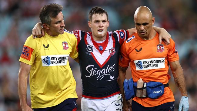 Luke Keary is helped from the field with a serious knee injury.