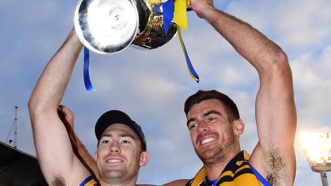 Eagles premiership stars Jeremy McGovern and Scott Lycett hold the cup aloft on Saturday. Picture: AAP Image/Julian Smith