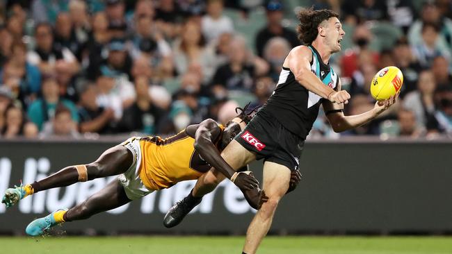 Darcy Byrne-Jones of the Power is tackled by Changkuoth Jiath of the Hawks during the 2022 AFL Round 02 match between the Port Adelaide Power and the Hawthorn Hawks at Adelaide Oval on March 26. Picture: Sarah Reed/AFL Photos via Getty Images