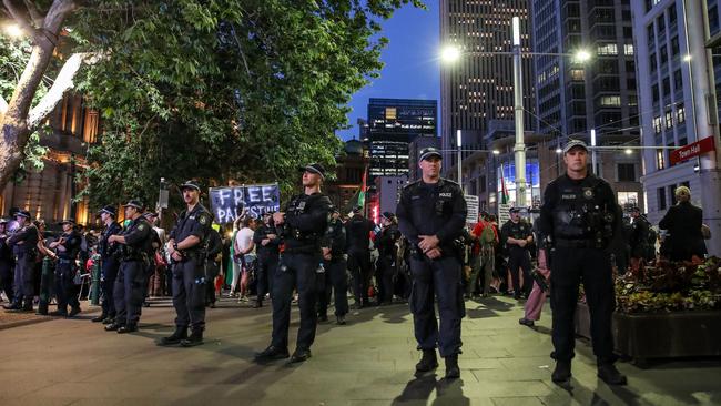 NSW Police stand guard during a vigil outside Sydney’s Town Hall on October 07, 2024. Organisers said the event was to remember lives lost in Gaza and Lebanon since October 7 last year. The organisers, Palestine Action Group, invited people of all faiths to “unite in solidarity in our call for justice and solidarity”. Picture: Roni Bintang/Getty Images