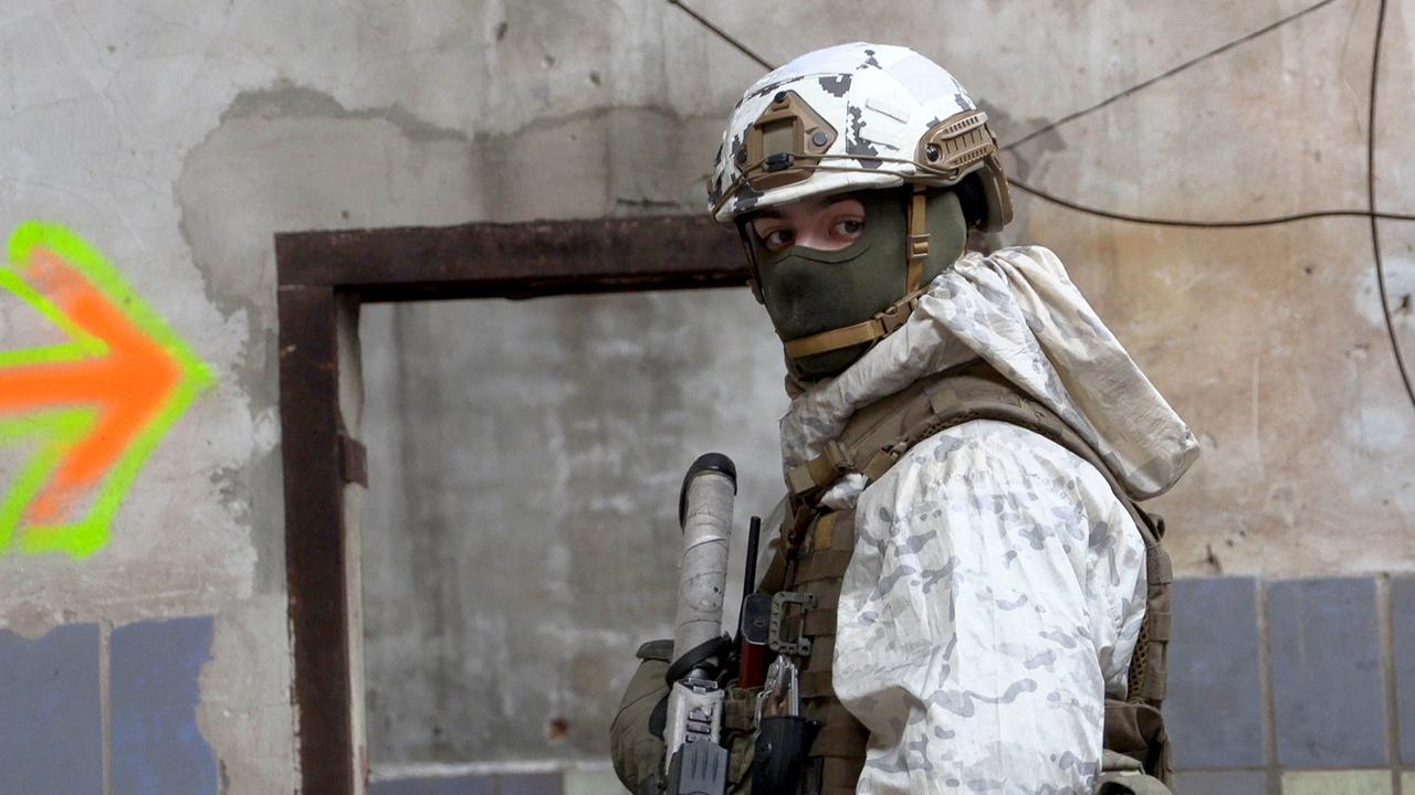 A serviceman of Ukrainian Military Forces stands guard at the destroyed industrial zone in town of Avdiivka on the frontline with Russia-backed separatists. Picture: Will Vassilopoulos/AFP