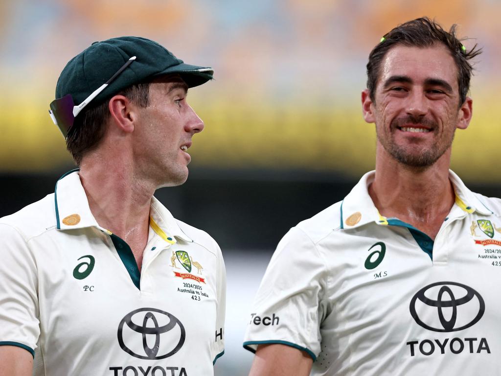 Pat Cummins, left, with Mitchell Starc as they left the ground due to a rain delay on day five of the third cricket Test match between Australia and India at The Gabba in Brisbane on December 18. Picture: David Gray/AFP