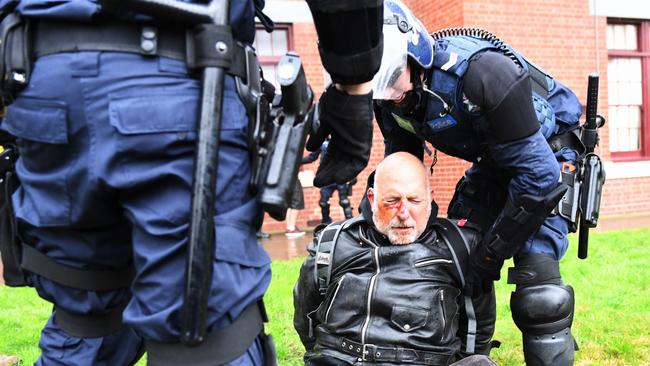 Police arrest a member of the United Patriots Front. Picture: Jake Nowakowski