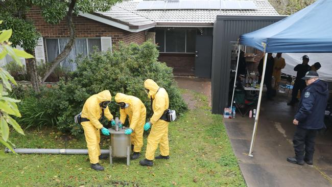 Police begin to remove the sophisticated drug production equipment from the clandestine laboratory uncovered at Morphett Vale. Picture Dean Martin