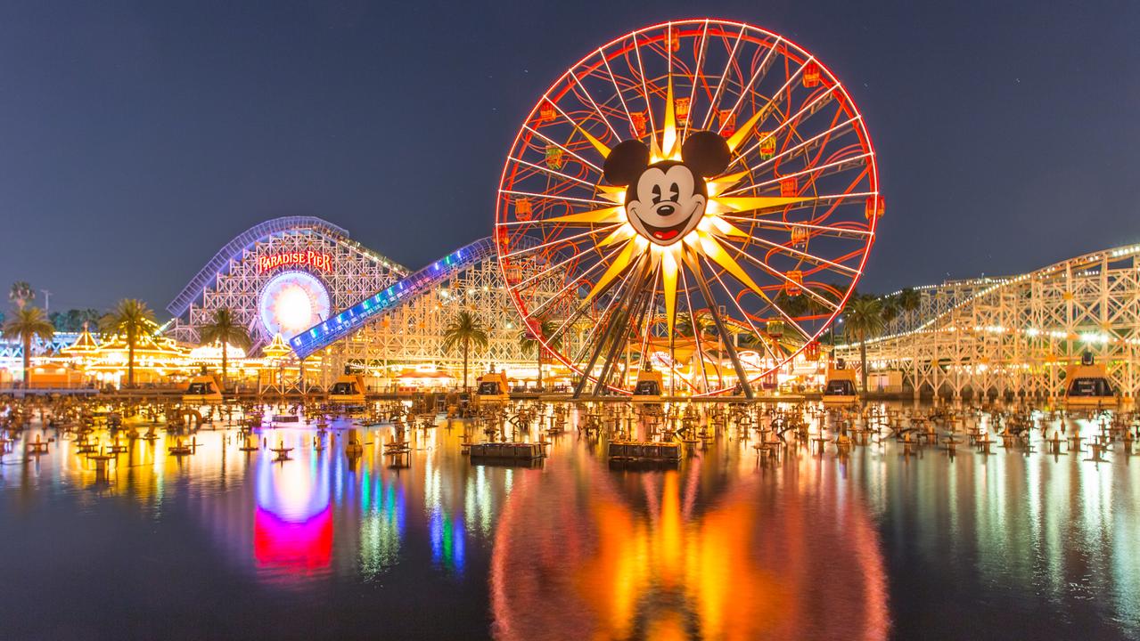 Anaheim, CA USA - August 22, 2015: Disneyland 60th aniversary at Cars Land. This year Disneyland celebrates its 60th aniversary of been open. On this day the park celebrated with fireworks and over 150 thousand people. People walk around rides and games at the downtown Cars Land during the night time..