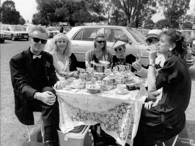 Punters Mark Ward, Rhonda Ward, Sue Cleland, Caroline Mornane, Robert Ward and Laura Huntley enjoy themselves in the Flemington carpark in 1986.