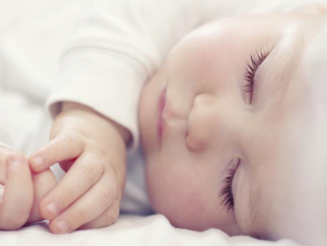 close-up portrait of a beautiful sleeping baby on white