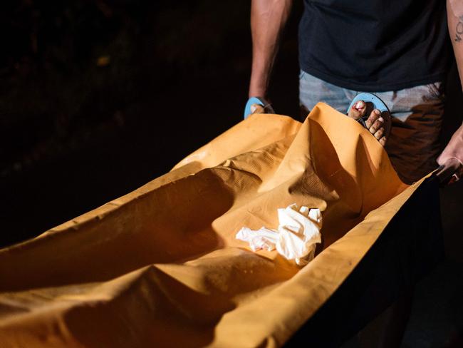 A stretcher with the body of an alleged drug dealer murdered by unidentified assailants in July in Manila is taken away. Picture: Noel Celis/AFP