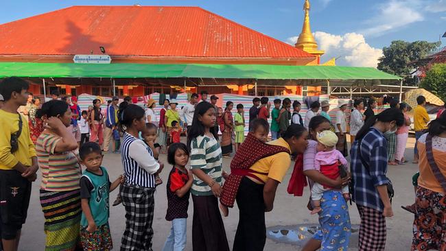 People queue for food at a monastery-turned-temporary shelter for internally displaced people (IDP) in Lashio, Shan state in November last year. Picture: AFP