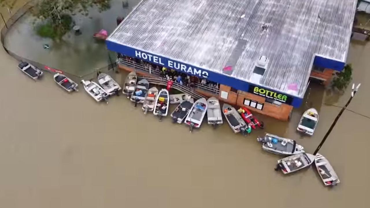 Despite record-breaking floodwaters, patrons of a small country pub braved the floodwaters in their dinghies to get a beer. Picture: Facebook/ Hotel Euramo