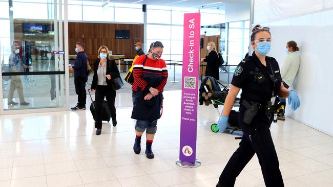 Passengers wearing masks at the Adelaide Airport. Picture: NCA NewsWire / Kelly Barnes