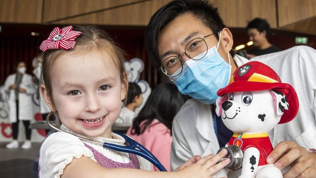 Mia Foo-Basic has her teddy bear checked by Sean Yip at the Teddy Bear Hospital during the 2022 Good Friday Appeal. Picture: Aaron Francis