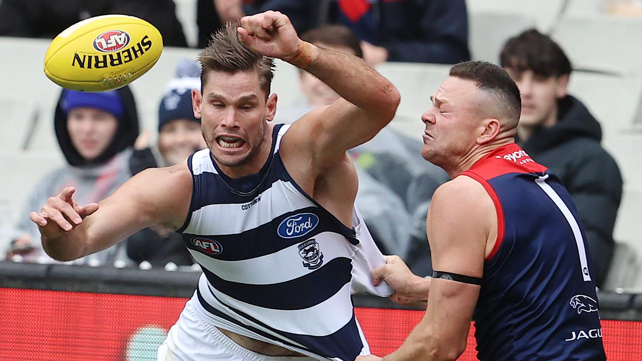 May grimaces after Tom Hawkins collides with him. Picture: Michael Klein