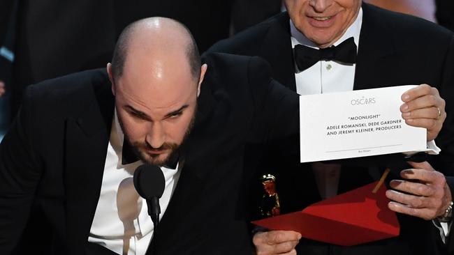 'La La Land producer Jordan Horowitz holds up the winner card reading actual Best Picture winner 'Moonlight' with actor Warren Beatty behind. Picture: /Getty Images.