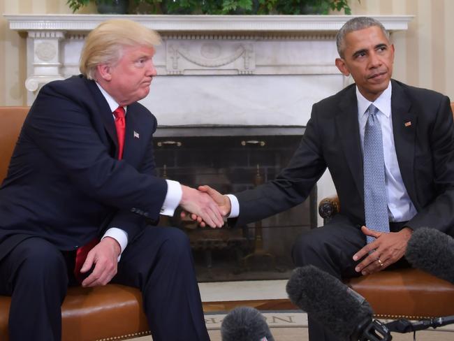 No love lost: Donald Trump and his presidential predecessor Barack Obama shake hands. Picture: AFP