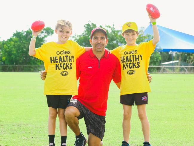 Halle and Jagger Baines with Eddie Betts as he hosts a Kicks clinic in Palmerston. Picture: Glenn Campbell