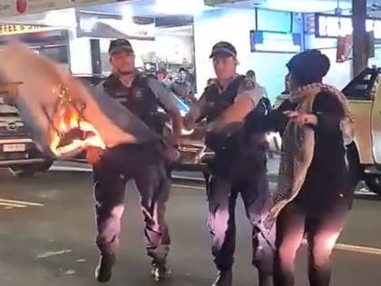 A woman was burning an Israeli flag in Lakemba on Tuesday night as about 200 people protested about recent missile attacks in Gaza. Picture: instagram https://www.instagram.com/p/COu1FEVhjI6/