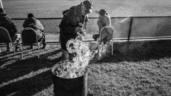 A footy fan keeps warm on a winter day.