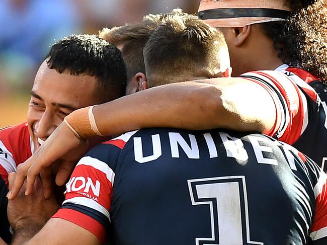 BRISBANE, AUSTRALIA - MAY 12: James Tedesco of the Roosters is congratulated by team mates after scoring a try during the round nine NRL match between the Sydney Roosters and the Canberra Raiders at Suncorp Stadium on May 12, 2019 in Brisbane, Australia. (Photo by Bradley Kanaris/Getty Images)