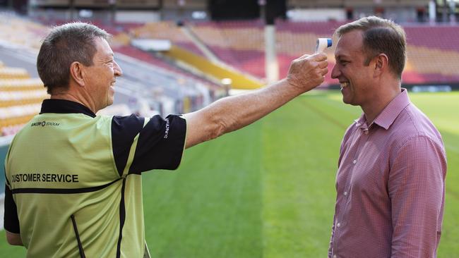 Deputy Premier Steven Miles gets his temperature checked at Suncorp Stadium in Brisbane. Picture: Attila Csaszar.