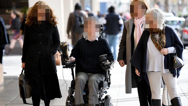 The accused shooter, in a wheelchair, with his supporters at the Adelaide District Court. Picture: Image AAP/ Mark Brake