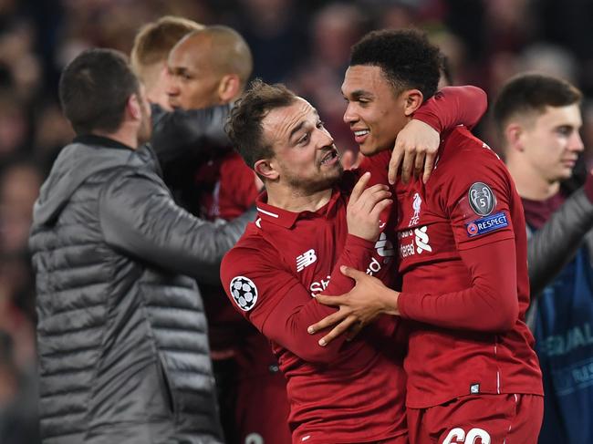 Liverpool's Swiss midfielder Xherdan Shaqiri (L) celebrates with Liverpool's English defender Trent Alexander-Arnold after winning the UEFA Champions league semi-final second leg football match between Liverpool and Barcelona at Anfield in Liverpool, north west England on May 7, 2019. (Photo by Paul ELLIS / AFP)