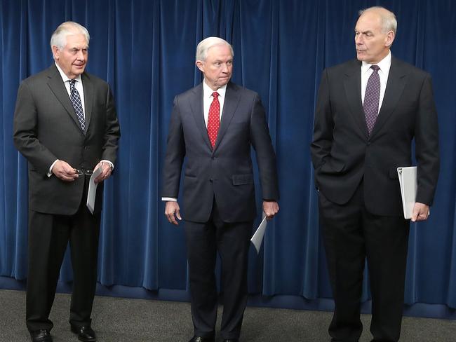 Secretary of Homeland Security John Kelly (R), Secretary of State Rex Tillerson (L) and Attorney General Jeff Sessions  at a press conference about the revised order. Picture: Getty Images.