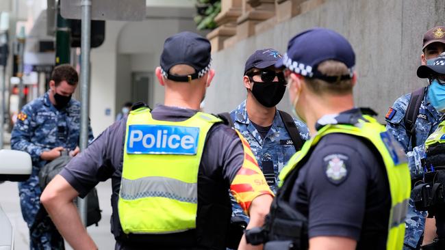 Australian Defence Force personnel and police officers at the Pullman Hotel, where people quarantining at the Holiday Inn were moved to. Luis Ascui/Getty Images.
