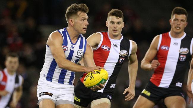 Shaun Higgins puts North Melbourne on the attack.