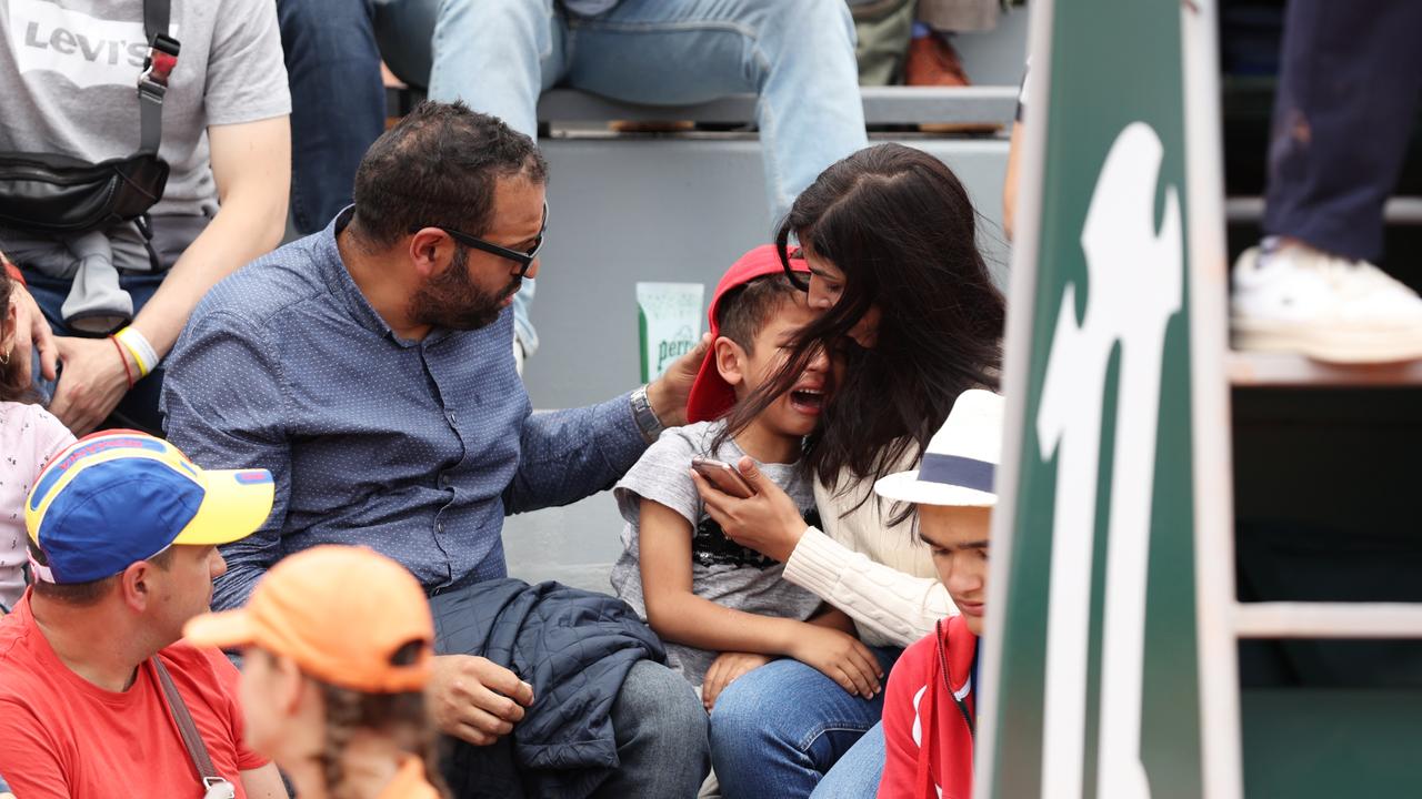 Parents comfort their child. Photo by Clive Brunskill/Getty Images