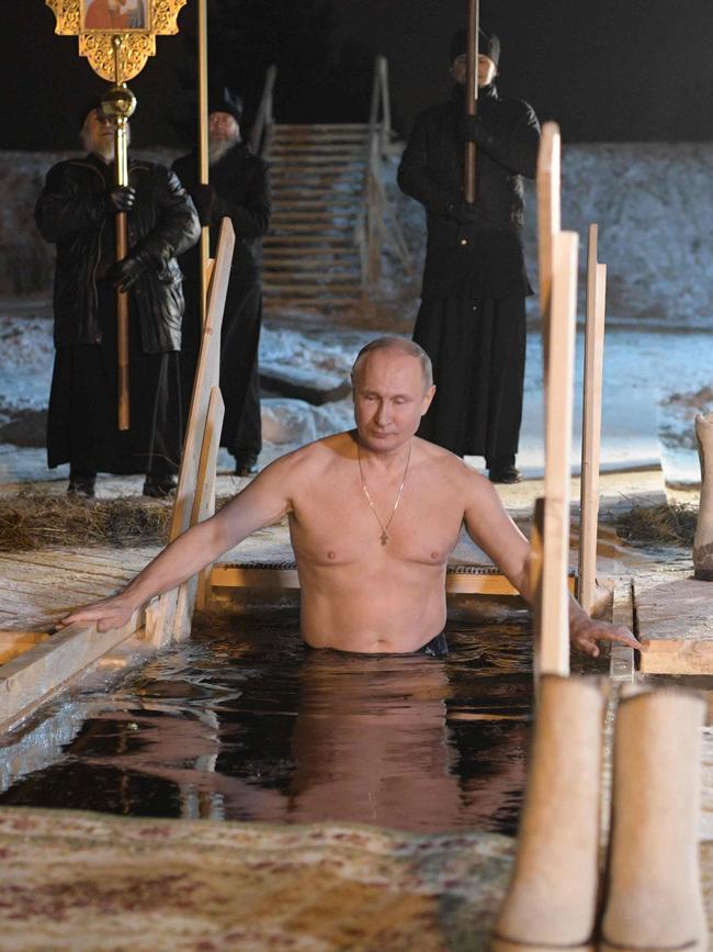 Vladimir Putin plunges into the icy waters of Lake Seliger during the celebration of the Epiphany holiday in Russia's Tver region.