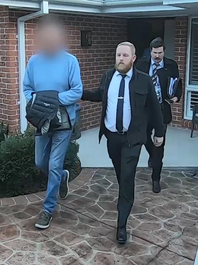 The former teacher being arrested at his Woolooware home. Picture: NSW Police