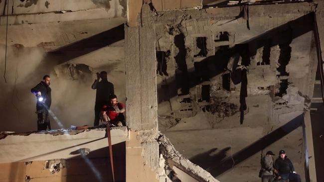 Rescue workers search the remains of the Beirut building hit by the Israeli airstrike that killed Saleh al-Arouri. Picture: Getty Images