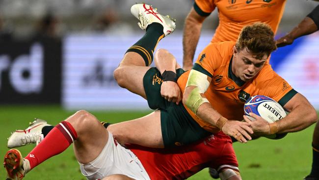 TOPSHOT – Australia's fullback Andrew Kellaway (up) is tackled by Wales' inside centre Nick Tompkins during the France 2023 Rugby World Cup Pool C match between Wales and Australia at the OL Stadium in Decines-Charpieu near Lyon, southeastern France on September 24, 2023. (Photo by SEBASTIEN BOZON / AFP)