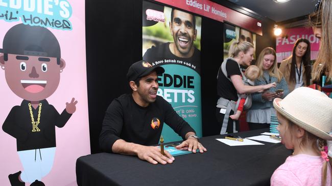 Eddie Bets signs his children’s books at the Royal Adelaide Show on Sunday. Picture: AAP / Mark Brake