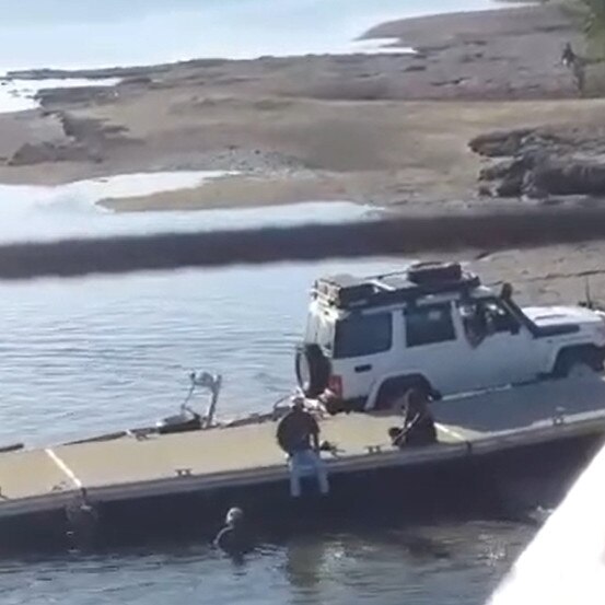 A woman was filmed swimming in croc infested Elizabeth River.