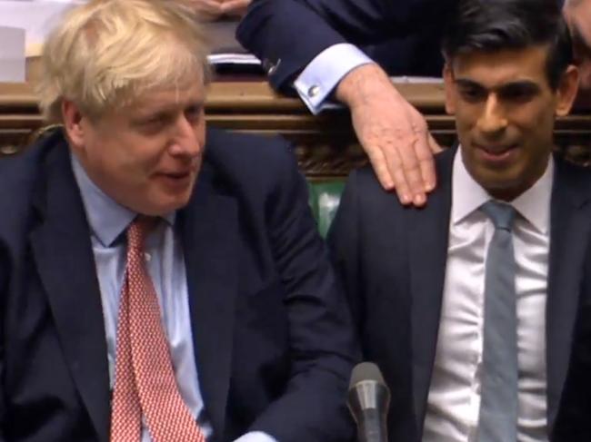 British finance minister Rishi Sunak with Boris Johnson after the $60 billion plan was unveiled. Picture: AFP