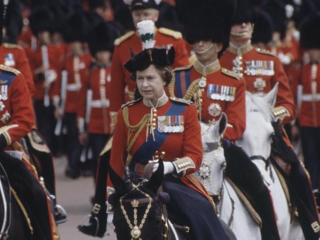(FILES)  Queen Elizabeth II riding sidesaddle during the Trooping the Colour procession, London, 13th June 1981. Behind her are Prince Charles (left) and Prince Philip. (Photo by Tim Graham Photo Library via Getty Images)