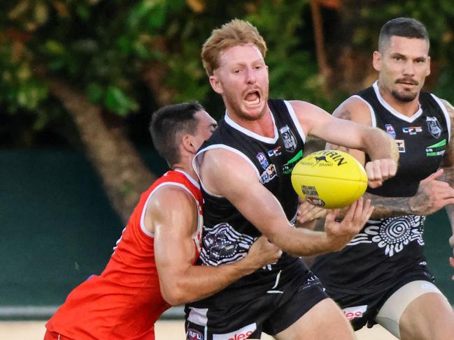 Palmerston's Eric Guthrie caught in a tackle against Waratah in Round 4 of the 2022-23 NTFL season. Picture: Celina Whan / AFLNT Media