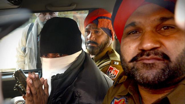 Puneet Puneet, SUNDAY HERALD SUN. Puneet Puneet arrives under police escort at the Judicial Court Complex in Rajpura surrounded by local media.