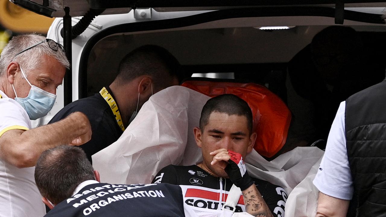 TOPSHOT - Team Lotto Soudal's Caleb Ewan of Australia reacts as he is evacuated after falling close to the finish line of the 3rd stage of the 108th edition of the Tour de France cycling race, 182 km between Lorient and Pontivy, on June 28, 2021. (Photo by Anne-Christine POUJOULAT / POOL / AFP)