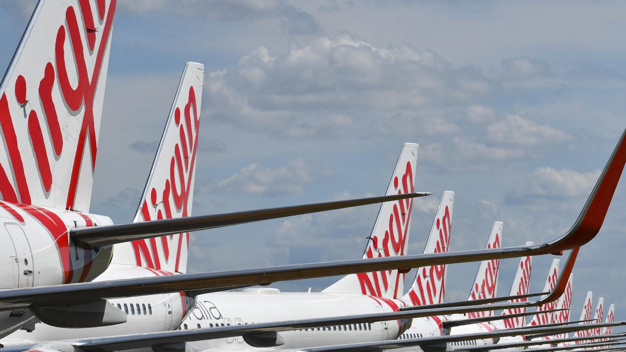 Grounded Virgin Australia aircraft are seen parked at Brisbane Airport. Picture: Darren England/AAP